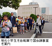 写真：地元小学生を自転車で国会議事堂を案内