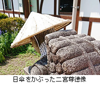写真：日傘をかぶった二宮尊徳像